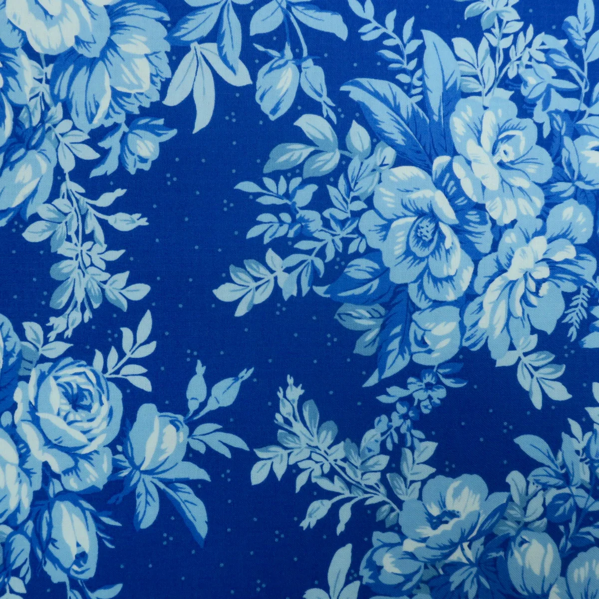 Blue roses printed on navy cotton fabric